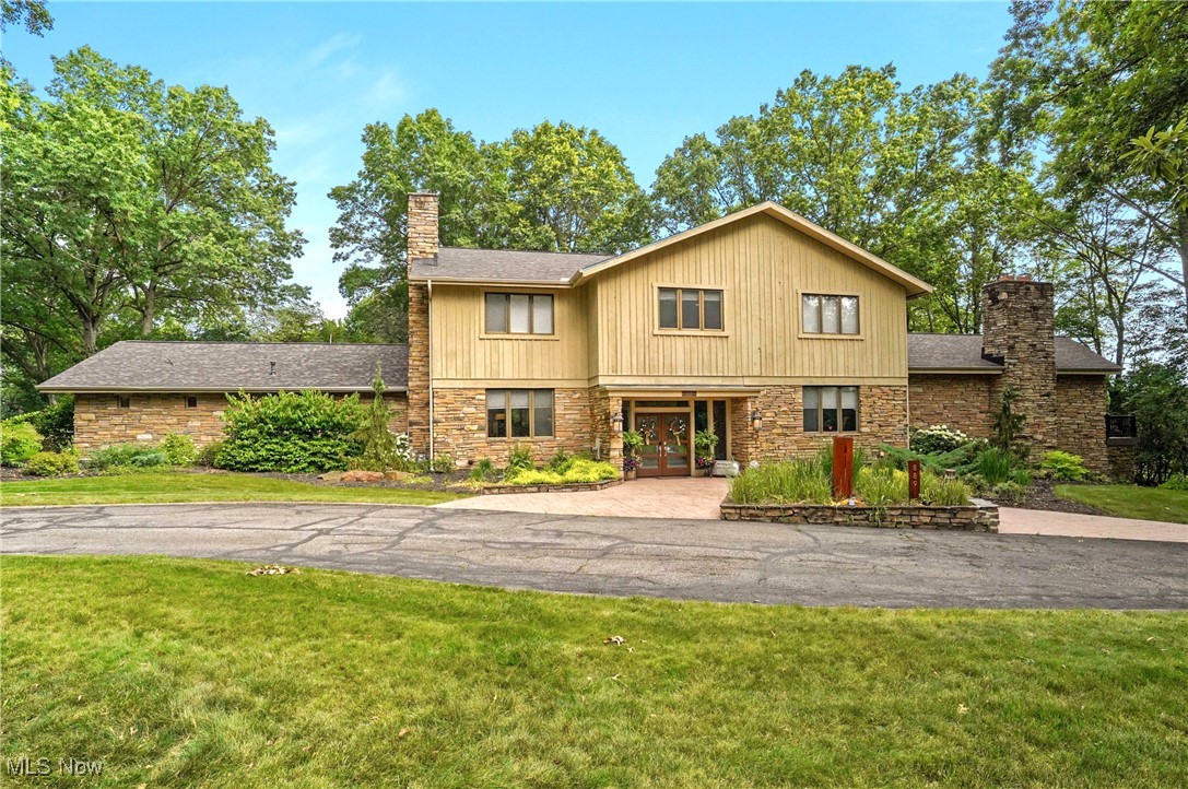 Welcome to 889 Eaton Ave., a Marchetta built stone and cedar contemporary home offering over 5,600 Sq. Ft. plus approximately 1,110 in the walk out lower level. Step inside the front door to the open foyer and your eyes will immediately see the wonderful open floor plan. To the left you'll enter the living room with fireplace that mergers into the eating area on your way into the white and bright, fully applianced kitchen with center island, breakfast bar and plenty of cabinets and storage. The kitchen connects to the spacious formal dining room and the wonderful Sun room overlooking the multi level patios, newer Trex decking and the large open back yard with plenty of trees. The main Great room is UhMazing! This room is about 41x25 with 14 Ft. high ceilings, great lighting and a huge stone wall with fireplace.. This is a super space for entertaining with walls of windows. There is also a first floor office with walls of built-ins and 2 half baths. The 2nd floor includes 5 bedrooms with ensuite bathrooms and great closet space in each as well as the hallway that is filled with storage closets. Some recent improvements: New roof in 2021, Decking 2023, new carpet throughout in 2024, EV charger added, invisible fencing, Updated lighting: garage, laundry room, kitchen, office and outdoor lighting in the back, new microwave and cooktop and front landscaping in 2020. This location is ideal and close to downtown, the metro park area and great shopping and restaurants. Home is in the King school cluster