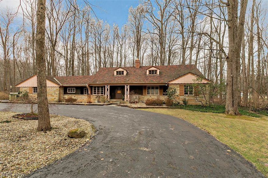WONDERFUL opportunity for the next owner to make this house their home.  This mid-century home rests on 3.4 acres in Gates Mills and features an expansive living room and dining room with wrap around fireplace, hardwood floors and lots of natural light – perfect for entertaining.   Most rooms on the first floor have recently been painted in today’s neutral tones.  The first floor also includes two bedrooms, 1.5 baths, a newly carpeted family room with vaulted ceilings and marble fireplace.  Walk out to the BONUS area - a screened porch with brick hearth and enjoy the peaceful setting.  The laundry room is also on the first floor right off of the attached 3-car garage.  The second floor features two oversized bedrooms with hardwood floors and a full bath.  Multiple cedar closets and storage at every turn!  The unfinished, wide open lower level (w/fireplace) is ready to customize as the new owner desires.  Bring your finishing touches and it WILL be spectacular!   Tile roof, HVAC and sep