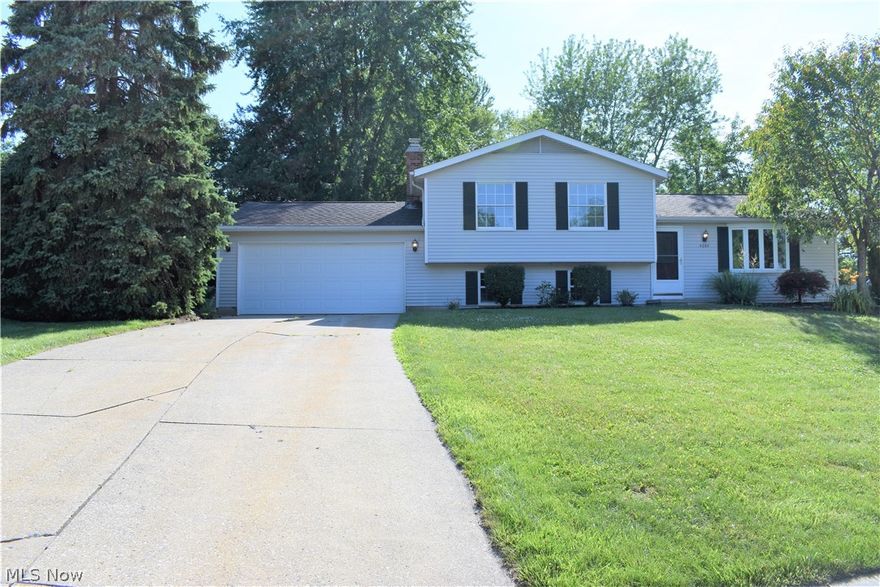 Come see this all redone, spacious four level split situated on a large park like fenced in lot in Stow! Remodeled and tastefully done in today's modern decor with fresh paint and new flooring throughout.. This home features an open white kitchen with granite tops and stainless steel Samsung appliances, a dining room with a slider that leads to a huge patio, family room with wood burning fireplace, finished lower level that can be used as a 4th bedroom or rec room, bay window in front, extra long double driveway and a deep garage. Many updates. A must see!