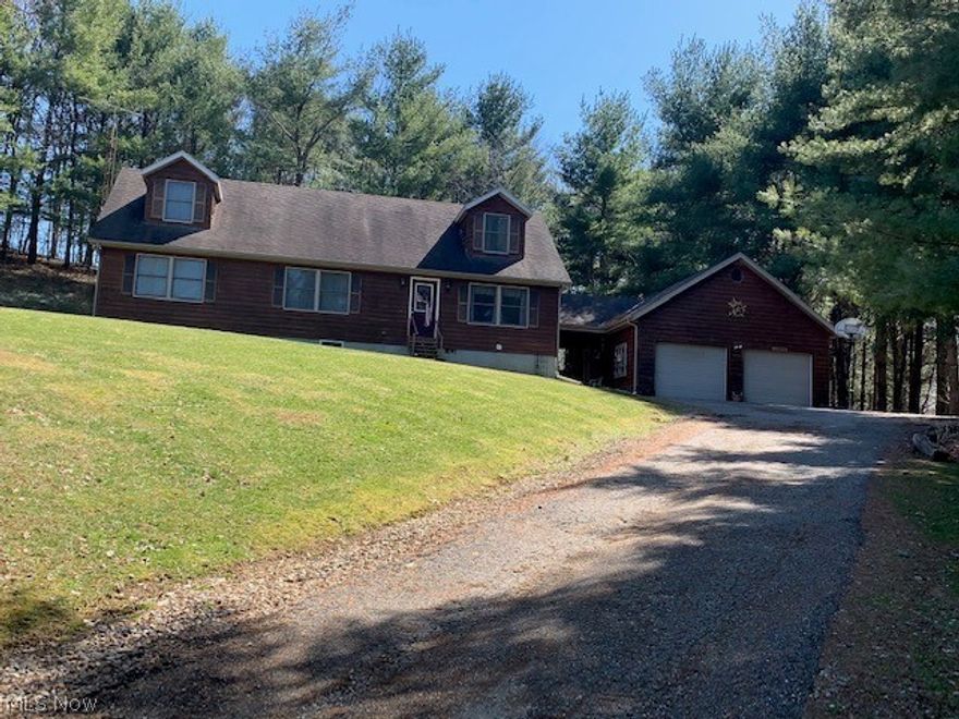 Come fall in love with this charming cedar-sided Cape Cod home situated on 5.001 acres. Enjoy the sights and sounds of nature relaxing on the back deck. The first floor offers the living room which is open to the kitchen, dining room with patio doors to the outside deck, laundry, one bedroom and master bedroom with full bath. Large kitchen with beautiful new flooring, island/bar area and plenty of cabinet space. Upstairs are 2 more large bedrooms with built-in storage/dressers, a full bath and extra large closet. Easy to finish, very open and spacious walk-out basement with already a full bath and beautiful tile shower. Go through the breezeway to the large detached garage with loft area for more storage. Won't last long so schedule for your private showing today.