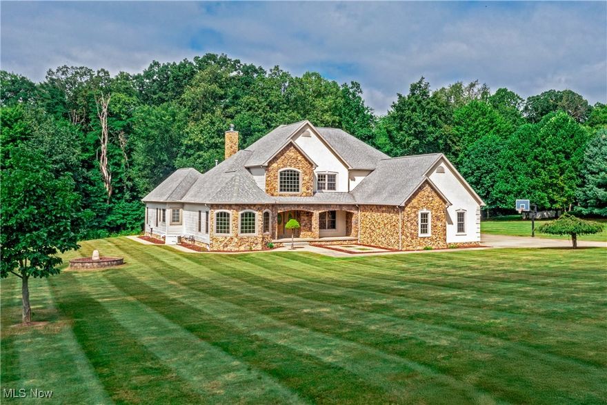 Set on 2 private acres, this magnificent custom-built colonial was designed to impress at every turn. From the moment you step inside, you’ll be struck by the home’s soaring scale, exquisite details, and masterful craftsmanship. 
The dramatic two-story foyer sets the stage for grand-scale entertaining and intimate gatherings alike, with 20-foot ceilings and sweeping sightlines that pull you into the heart of the home. The dining room stuns with a tray ceiling and dazzling chandelier, and the soaring great room provides a perfect backdrop for memories to come. 
The chef’s kitchen blends showpiece design with pro-level function. Custom cabinetry, granite counters, and a wall of windows with tailored blinds set the scene, while a professional-grade Viking cooktop with hood, a wall oven/microwave combo, beverage cooler, and dedicated ice maker make entertaining effortless.
The main-floor owner’s suite is a private retreat with vaulted ceiling, his-and-hers closets, spa bath, and patio access, blending indoor comfort with outdoor ease. Upstairs offers three spacious bedrooms, including one ensuite and a Jack & Jill layout. The finished lower level transforms into the ultimate entertainment hub: billiards, foosball, air hockey, basketball, a home gym setup, dual TV lounges, and a full bath with an oversized step-in shower. 
Every practical detail has been considered: first-floor laundry with washer and dryer, 3-car heated garage with key lock storage, drains, hot/cold water, and three openers. Whole-home luxuries include a sound system, surveillance system, Generac generator, two Lennox furnaces, and Rinnai tankless water heater.
Outside, enjoy stamped concrete walkways, a stone-covered front porch, concrete patios with retractable awning, sprinkler system, and beautifully landscaped grounds that create a seamless blend of luxury and nature.
More than a home—this is a lifestyle statement. Schedule your private showing today.