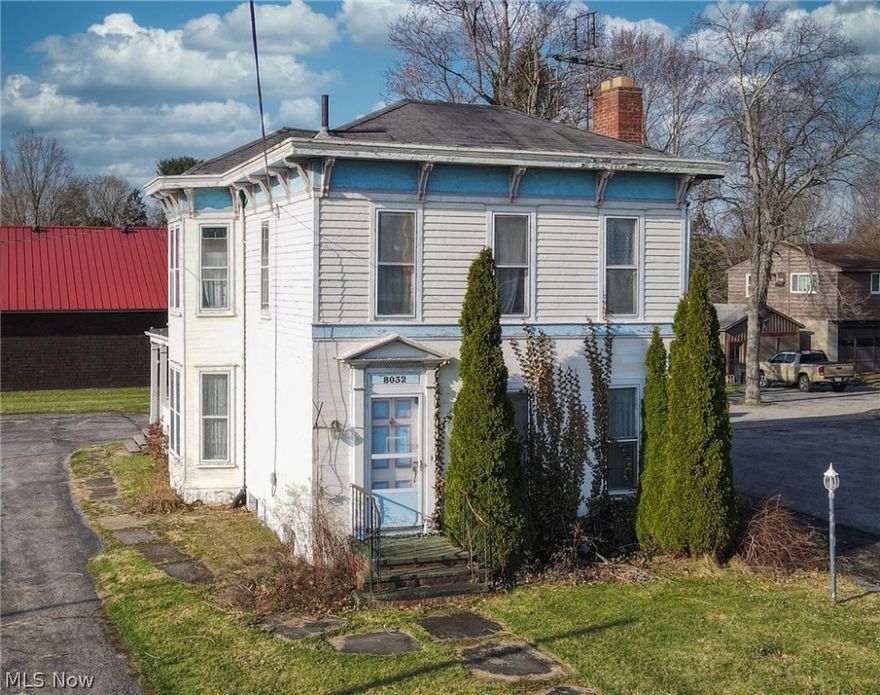 Victorian Century Home in the Heart of Garrettsville! Great opportunity for your residence, small business (Commerical), or both. Dual Staircases, tall ceilings, and Lots of Charm! The first floor offers a spacious Living Room with a wood-burning fireplace, wood floors, and Curved Staircase leading to the second floor. The first-floor Den with a Full Bath off the Formal Dining Room with wood floors, Spacious Eat-in Kitchen, and a large Mud/Laundry Room at the rear side entrance (need to add hook-ups). Spacious Second Floor with Four Large Bedrooms, a Full Hallway Bath, and Rear Staircase that can serve as a private entrance to the fourth bedroom with wood floors and a Cedar Closet.
The side entrance off the drive has a covered porch and access to the walk-out basement. The home has approx 3/4 basement and the rest crawl space for ample storage, and access. Newer hot water tank. Forced air heat and central air.  Drive leads to the back with a large parking lot and turn around area. Det