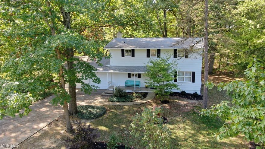 The bones are amazing here in this Kent, Ohio (Twin Lakes) 4 bed, 3 bath Colonial w/ newly painted exterior! Built by the Amish and with one long-standing owner, you'll fall in love with the wooded/natural area (with a view of Lake Spelman & with West Twin Lakes privileges including boating, beach use and clubhouse). Centrally located to Kent, Hudson and Streetsboro, it's also close to I-480 and the Ohio Turnpike. Walk into the home and you'll be greeted by a wonderful front entry hall with large coat closet. The spacious living room and family room (with wood burning fireplace w/ old barn beam mantle) both boast original hardwood floors! Sunroom, added in 1997, is going to call your heart home with its fantastic view of Lake Spelman, land-locked wetlands and wildlife! Rounding out the first floor is a dinette eat-in kitchen and a laundry/full bath combination. Four upstairs bedrooms are all spacious and boast hardwood as well. The Master bedroom has en suite bath. In 2015-16 a new sof