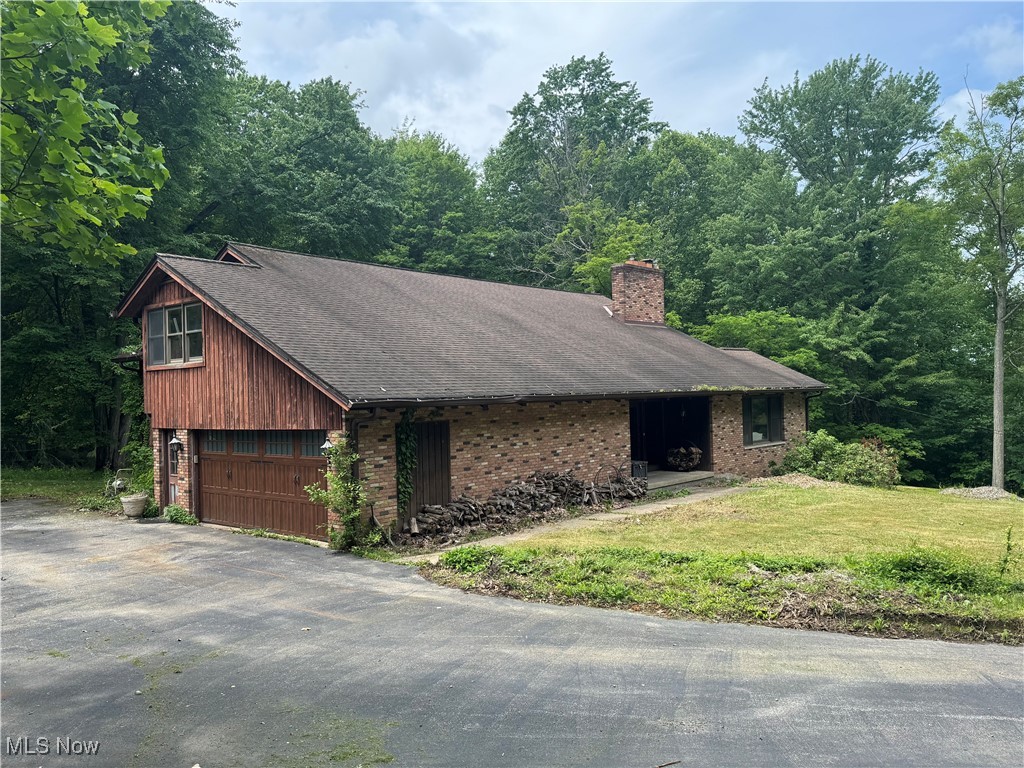 REDUCED and Ready for a redo! This 3K+ square foot resort-like home is in need of a make over. Huge potential for this 4 bedroom 3 bath nestled on 7+ of beautiful wooded acres. The large 3 car outbuilding could be converted into a barn.