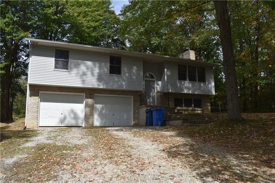 This is a well-cared for, one owner, raised ranch home on 1.99 acres in Springfield Township! Walk through the front door into a hardwood floor foyer with two staircases; one to the main floor and the other to the lower level with access to the double car garage. The main level has an open-floor concept with a large living room that moves into the dining room where there is a sliding glass door to a huge deck in the back yard. The kitchen, complete with breakfast bar, is off of the dining area and has a window over the sink with a great view of the back yard. All kitchen appliances convey with the house. There are also 3 nice-sized bedrooms with large closets and a fresh coat of paint; the master bedroom has two closets and private entry to bathroom. The full bath includes a shower, garden tub and single-sink vanity. On the lower level is a large family room with a fresh coat of paint and a walk-in closet with storage under the steps. The utility room is plumbed for another full bath and grants access to the double-car garage. This home has a brand new roof (2024), brand new AC (2024), and professionally cleaned carpets throughout (2024). Enjoy the large front and side yards, a beautiful back yard with deck, and a large section of woods to sit back and enjoy watching the deer explore the area!