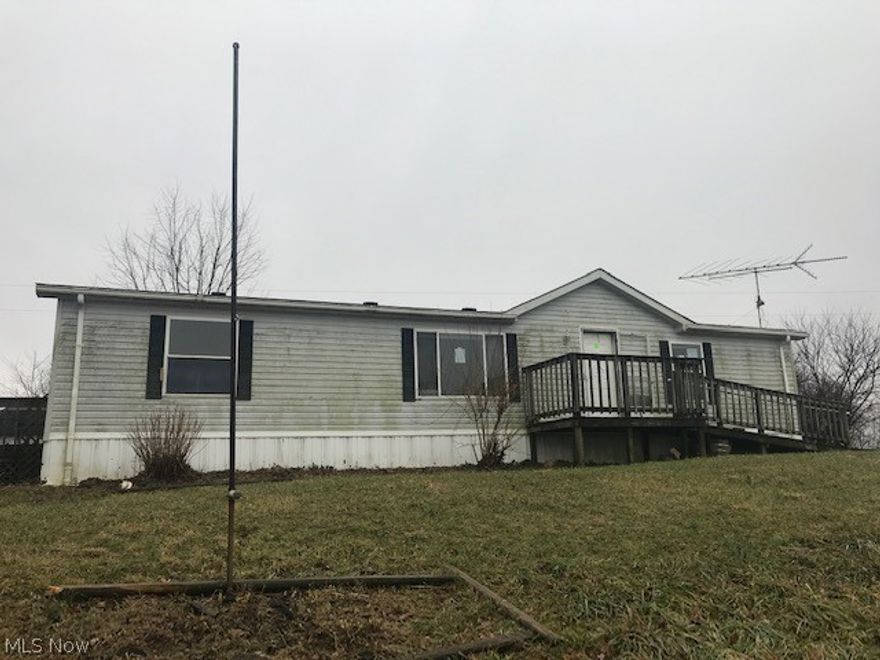 Manufactured home (taxed as real estate) on 10 acres.  Split floor plan with master bedroom, bath and walk in closet.  Open kitchen, dining and living room.  2 car detached garage and 2 storage sheds.
