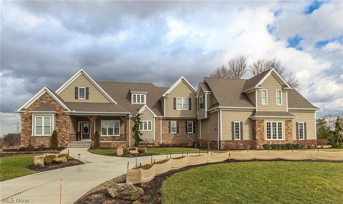 Beyond comparison this one of a kind builders own home it truly extraordinary. The home sits atop the street with million dollar views. Completed in 2013 the home offers remarkable quality throughout, with a layout and design to perfection! The amazing chefs kitchen features trey ceiling W/ crown molding, custom hand glazed cabinets, 14FT center island, stone accent wall & hand scraped hardwood flrs. Off the kitchen you can access the cover deck w/ wood ceiling & remarkable outdoor kitchen. The great rm boasts gorgeous coffered & trey ceiling, custom stone fireplace & built-ins. The master suite has his & hers walk in closets awesome glamour bath with huge tile shower. The guest bedrooms each has a private bath W/ granite counter. Venture downstairs to the finished walk out basement with access to the extra attached 3 car garage with room above that's plumbed and wired for possible in law suite or home office making a TOTAL of 6 car garage. Basement features wet bar family media room w