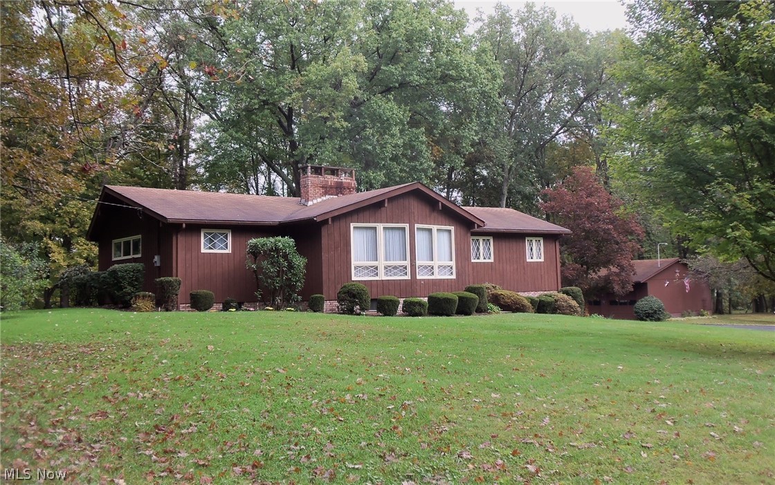 Oh what a beautiful property! First time on the market for this lovingly maintained, original owner home. 4.76 picturesque acres with beautiful mature Maple, Walnut and Hickory trees and abundant garden area. 2100 Sq.Ft. Hillside Ranch features eat-in kitchen, 4 bedrooms, 2 full baths and laundry on the main floor. Spacious living room boasts vaulted beamed ceiling with stunning natural Stone fireplace. Generous eat-in kitchen offers appliances, breakfast bar, desk station and dining area with access to large rear deck overlooking backyard barbeque, beautiful mature trees and stone bottomed creek with bridge. Partially finished lower level has roomy Rec. room with 2nd fireplace, wet bar, plenty of storage in the unfinished area and 2 car garage. Third full bath was added to lower level for those sunny days of playing or working in the fabulous yard or woods. 40x28 detached garage/outbuilding with electric and water and 2 OH doors that could easily be converted to add a couple stall