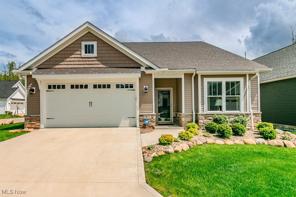 Absolutely stunning and meticulously enhanced, this newer construction ranch home at 7895 Fox Hunter Lane offers elegant, one-floor living in the prestigious Highgrove Villas at Quail Hollow, Concord Township. Built in 2023 and thoughtfully upgraded since completion, this three-bedroom, two full bath residence showcases sophisticated design, exceptional craftsmanship, and modern functionality throughout.
Step inside through a welcoming foyer adorned with premium vinyl plank flooring that flows seamlessly across the entire home. Two forward bedrooms are complemented by a stylish full guest bathroom, ideal for visitors or a home office setup. The heart of the home is an expansive great room featuring vaulted ceilings, recessed lighting, and a striking gas fireplace framed in stone. This open-concept space effortlessly transitions into a designer kitchen with granite countertops, ceramic tile backsplash, upgraded cabinets with soft-close hardware, and a full suite of stainless steel appliances—including an upgraded range and refrigerator. A dining area is elegantly defined by a custom chandelier, and sliding glass doors lead to a fully enclosed rear sunroom with Nature Stone flooring, adding over 250 square feet of finished, multi-season living space.
The owner's suite is a sanctuary of light and space, highlighted by a wall of picturesque windows and a luxurious en-suite bath featuring a double vanity, frameless glass walk-in shower, ceramic tile, and upgraded fixtures. A dedicated first-floor laundry room with an additional utility sink and included washer/dryer enhances daily convenience.
Beyond its pristine interior, this home offers professionally landscaped grounds with full lawn installation, front and rear shrubbery, and stone perimeter detailing. Additional upgrades include custom window treatments, an Anderson storm door, ADT home security system, and garage enhancements such as insulation, paint, bike racks, and 220V electric access. Must See.