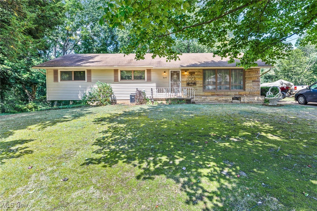 Welcome to **3211 Sherbrook Dr.**, a charming 3-bedroom, 2.5-bath ranch with a 2-car garage, set on a spacious **.92-acre lot**. Lovingly owned by the same family since it was built, this home is ready for its next chapter. With a little TLC, it has the potential to shine once again. Inside, you’ll find **first-floor laundry**, three bedrooms on the main level, and a kitchen that was updated not long ago with **stainless steel appliances** and **granite countertops**. Just off the kitchen and dining room, the **enclosed porch** opens to a back deck, perfect for enjoying the outdoors. The **partially finished basement** offers additional living space, a half bath, and walkout access to the backyard. This home is conveniently located just **7.9 miles from Akron-Canton Airport**, **2 miles from Springfield High School**, and **2.5 miles from shopping, dining, and fitness facilities**. Don’t miss this opportunity to create the home of your dreams—opportunity is knocking at Sherbrook Drive!