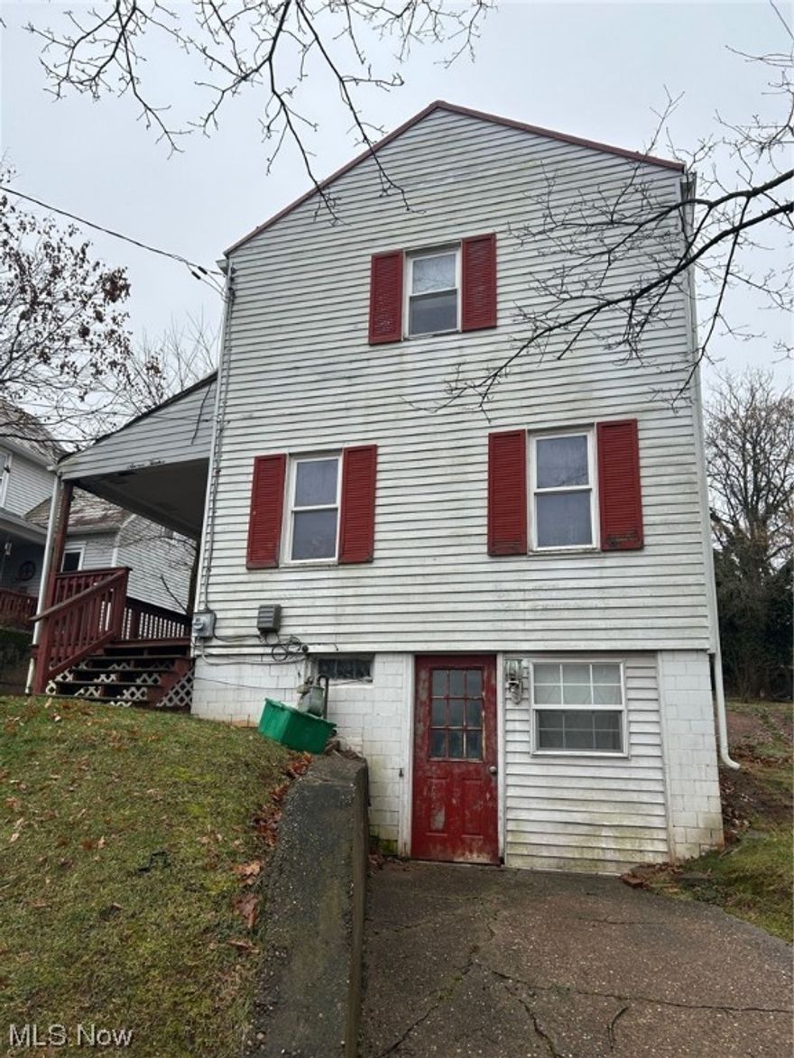 Property being sold "as is". First floor offers living room with original wood floors and eat-in kitchen that leads you to oversized, covered back patio.  Second floor offers full bath with two bedrooms with wood floors.  Full walkout basement, storage shed, off street parking.