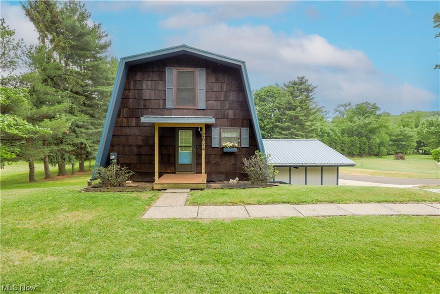 Online Only Auction 8/9- : Tranquil and unique, this home is a must see. A charming wood A-frame home with 2-car garage. The main floor is made up of the living room with spacious vinyl back deck, kitchen, bathroom. Both bedrooms and a full bathroom are upstairs. The lower level has a man cave & the laundry. Utilities to the home are electric forced air furnace, central air with heat pump, well & septic. The home features a newer steel roof. Located near the Breitenbach Winery between Sugarcreek & Dover, this property offers investment & Airbnb potential. Contact us today!