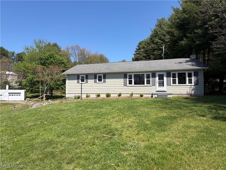 Charming 3 bed, 2 bath ranch set on 2.64 acres with a perfect blend of comfort and functionality. This well-maintained home has a newer kitchen and updated bathrooms, along with a 2023 furnace and A/C for peace of mind. The kitchen comes equipped with newer refrigerator, range, and microwave, plus a water softener system. Outside, enjoy both an attached garage and a detached garage/workshop ideal for hobbies, storage, or extra workspace. The wooded setting with a peaceful creek running through the property offers privacy and a beautiful natural backdrop.