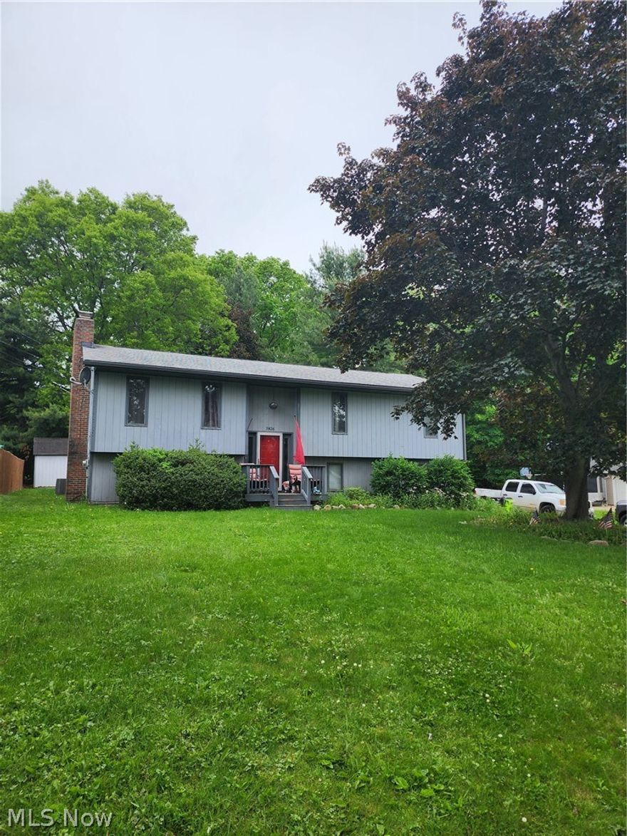 Spacious Bi-Level with fireplaced family room. Vaulted living and dining rooms. First floor master with private bath and walk-in closet. Roof gutters and downspouts in 2017. New furnace in 2025 and New hot water tank 2025. 2-car attached garage, slider to 2-tier deck and paved drive(needs some repair). Great location near Stow/Kent shopping and restaurants. Convenient to highways and University. With a little love and some paint this home is ready to go!