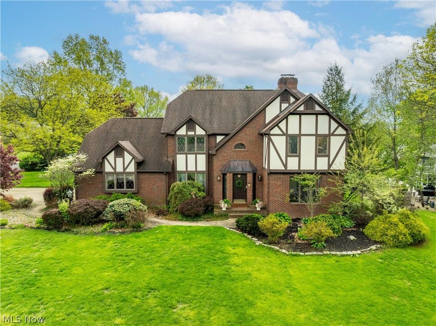 Stately Tudor-inspired brick home situated on a beautifully landscaped lot with timeless curb appeal in desirable Foxchase Hills. Featuring distinctive architectural details including steeply pitched rooflines, decorative half-timber accents, and classic diamond paned windows, this residence offers a warm blend of character and sophistication. Upon entry of the home you are immediately greeted by the open, turned staircase and 15 ft ceilings. Oak harwood floors flow through the first level and complement the cherry crown molding that's found throughout the main areas of the home. The front living room has recently been updated with new carpet and paint. The hallways, dining room and 4th bedroom/office and kitchen have also been repainted. The open kitchen is warm and inviting with cherry cabinetry, Cambria quartz counters, new lighting, new cabinet hardware and Stainless steel applainces. Off of the kitchen a passthrough bar connects to the great room featuring a sloped 19 ft ceiling with sky light and stone floor to ceiling fireplace. Upstairs are 3 well situated bedrooms with walk- in closets. Off the 3rd bedrom is an additional large storage closet for extra household needs. The 2nd full bathroom is a split design featuring the shower area and vanity separate from the watercloset and another vanity. The master has a classic cherry wood style gas fireplace and spacious ensuite with pitched ceiling and skylights, double sinks with new faucets and vanity lighting, shower and seperate jetted soaking tub and was recently freshly painted. Downstairs the basement is fully finished with 2 rec areas and feautures a pool table that stays and a kitchenette/bar area with granite counters. Outside is more room for entertaining with a 2 teir trex deck, gazebo and koi pond with a waterfall and patio area. This home is truly one of a kind and ready for it's new owners! Agent owned.