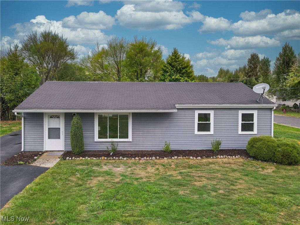 If you have been searching for a home with one level living, this house might be the one you call your next home! This Ranch-style 3 bedroom, 1 bathroom home is just under 1,200 square feet and has been newly updated so that you can simply turn the key, move right in, and begin your life here at 1489 Old Forge Rd. Mogadore Ohio 44260. As you make your way through the expansive living room big enough for 2 sitting areas, gaze out the front picture window and look at the unobstructed view you have of farm land and imagine yourself watching the sun rise and set each day. Next, tour to the eat-in kitchen and notice it also has great windows to look out into the back yard to watch the kids and pets play while you are sipping coffee at the table or preparing a meal in the kitchen featuring new countertops, sink, and stainless steel appliances. Down the hall, there are 3 modestly sized bedrooms and an updated full bathroom that all feature new flooring, fresh paint, new hardware, and new light fixtures. Pass through the laundry/mud room before going out the side door to the back yard and notice the convenience of having the extra space to remove shoes and coats right off the side entrance (always a plus)! The backyard is leveled and wide open, featuring a nice sized patio and a shed for all your storage needs. Situated in Brimfield Township and Field Local School District, this home is centrally located to farms, schools, parks, golf courses, and trails, as well as highway access for easy commuting, shopping and restaurants, Kent State and downtown Kent. Come tour 1489 Old Forge Rd. in Mogadore Ohio and find out what opportunities await when you make this house your next home!