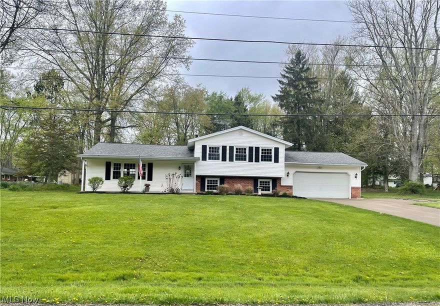 Welcome to this Stunning totally remodeled 3/4 Bedroom Split level in Northfield Center Township ! The renovations & custom finishes will WOW you!  Vaulted   great room with custom beam & lighting is one of a kind. New luxury vinyl plank gifts the entire first level.  The remodeled kitchen will stir up the chef in you with the abundance of cabinets, granite countertops & tiled backsplash. Note the custom wood shelves!  Step down into the family room for access to patio & yard for your summer fun.  Upper level hosts the master bedroom w/access to fully remodeled bath along w/2 additional spacious bedrooms gleaming with refinished hardwood floors.   Lower level offers an additional 4th bedroom or office & remodeled 1/2 bath.  Large laundry/mudroom/utility area hosts it's own custom natural wood bench within the locker area accessible from 2 car att garage. Second full bath has been added with beautiful, tiled shower and cabinet. 
Updates include fully remodeled kitchen & all baths, incl