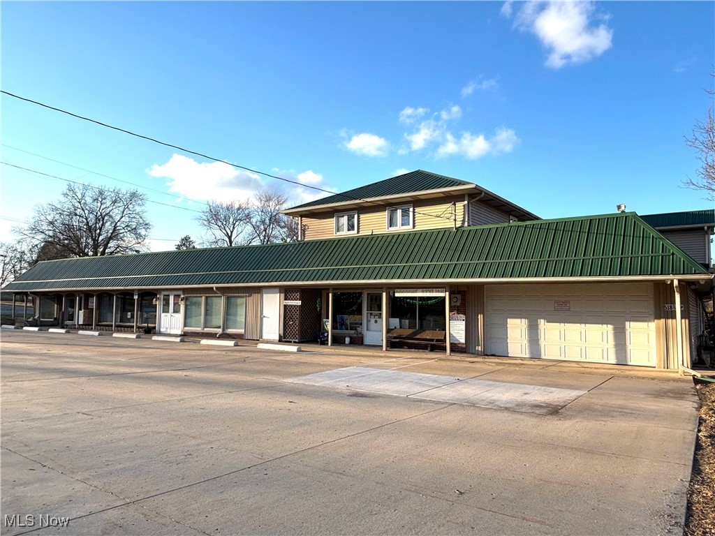Don't miss an opportunity to own this commercial property located in Columbiana, near Firestone Park. This 9,944 square foot building features three retail suites with separate entrances. Two suites are currently occupied and leased to stable tenants. The middle unit has endless possibilities and has several private offices. The property also has two apartments, a five-car garage, and several workshop areas that can also be used for storage. Recent updates include new furnace and central air. The building sits on 1.4 acres and has a metal roof. There is ample parking available for each business as well as additional parking along the side of the building. Zoned C-4. It's no secret that Columbiana continues to be a thriving community and many businesses are eager to establish themselves in this vibrant area!