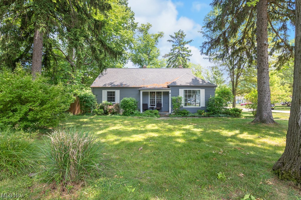 This updated cape cod is set back on a lovely corner lot. The fully renovated kitchen is over-sized, featuring tile floors, center island, open shelving, and a pantry. The recessed lighting and skylight contribute to the room's bright and airy feel. The spacious family room boasts a working woodburning fireplace and beautiful hardwood floors. The first-floor master bedroom includes two closets, the same beautiful hardwood floors, and an attached master bath with a newly updated walk-in shower. The home offers 3 full bathrooms, 2 on the main level and 1 upstairs, all of which have been updated. Other recent updates include a newer furnace (2013), newer central air (2013), newer hot water heater (2019), newer windows (2016), new double insulated French doors (2022), and newly refinished basement with two bonus rooms and a bar (2021). The tree-lined backyard features a brand-new privacy fence, a refinished wood deck.