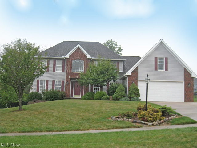 Simply stunning 4 bedroom, 2.1 bath, brick front colonial with a 1st floor master bedroom. This beautiful home offers a very open and neutral floor plan. The 2-story foyer with hardwood flooring leads to a den/office. Located off the kitchen is a spacious Great room with a gas burning fireplace. The large kitchen features all appliances, an island, pantry, backsplash, and sliding doors that lead to the private covered deck and yard. The master suite is complete with a glamour bath and large walk-in closet. Completing the 1st floor is a laundry room with cabinets and a guest bath. The 2nd floor has 3 additional bedrooms and a full bath. Completing this offering is a 2 ½-car attached garage, a full basement, a deck with lovely views of the backyard, and a large cement pad alongside the house. Located near schools, shopping, highway, the newly built North Royalton Library and YMCA! Shows beautifully!