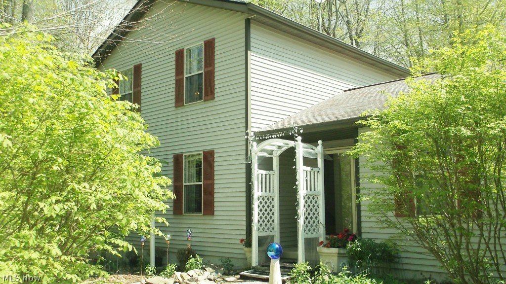 WOW! Just in time for summer, a beautifully maintained home in Hiram. In a country like setting this home is situated on over 2 acres of land and surrounded by trees. If privacy and being surrounded by the sounds of nature is what you want don't wait make an offer on this home today! The gravel circular driveway offers plenty of parking for guests, home offers plenty of space for entertaining inside and out. Recent updates include bathroom, flooring, sump pump, holding tank, septic & well inspected. Large wood deck off kitchen. Wood burning fireplace in living room. All kitchen appliances stay. Unfinished basement can be used for additional storage or converted for extra living space. Seller offering 1 year home warranty. Home is move in ready. Close to Hiram College. Motivated Seller! Hurry this one wont last!