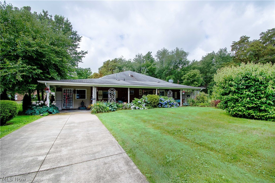 Welcome to this charming brick ranch-style home in Louisville. An expansive covered front porch (10x50') with nature stone floors welcomes you to an all-on-one-floor living: open floor plan and lots of space. The great room is spacious with two different fireplaces (wood-burning/pellet), two attractive expose ceiling beams, and it's open to the breakfast bar. The eat-in kitchen offers an abundance of cabinet storage (w easy pull-out drawers), appliances, ceiling fans and opens to the large formal dining room (with a fireplace) perfect for entertaining the whole family. There are three bedrooms with large closets, a large laundry room, a full bathroom, and a spacious four-seasons room. The attached one-car garage has cabinets & a working area. Updates include new flooring in the bathroom and hallways, new carpet in one bedroom (2020), central air unit (2018), furnace (2014 ), lighting fixtures (2019-2020), motion detector lights on the back of the house (2011), etc. Convenient to parks,