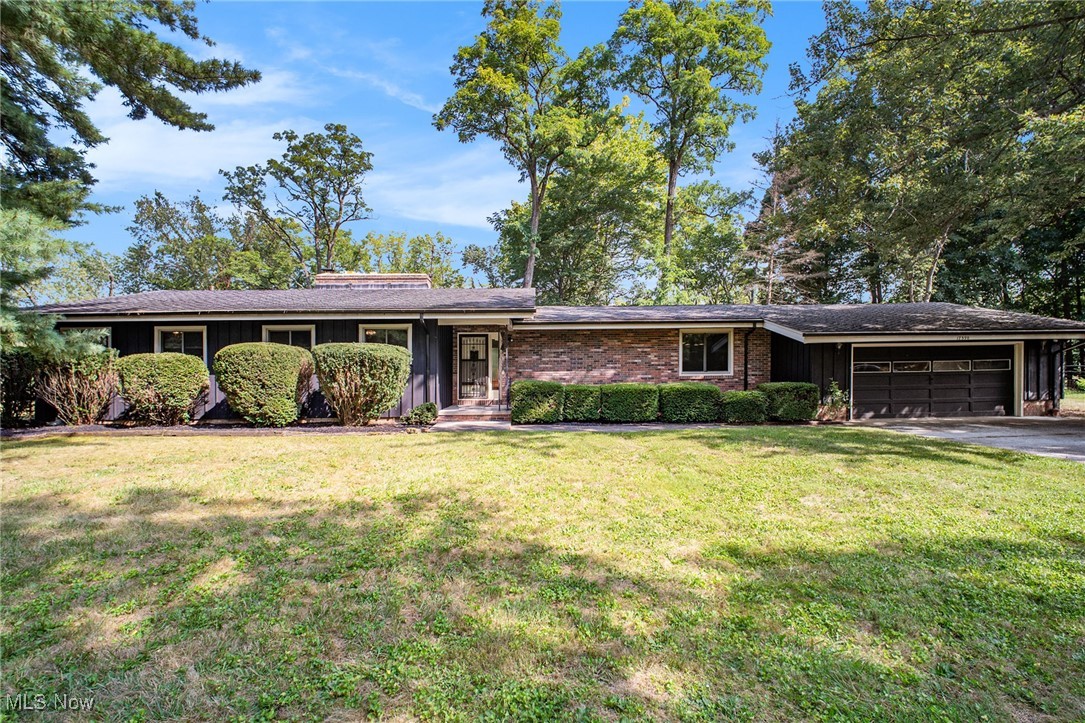This custom unique home which was built ahead of its time is a must see. The nice setback off the road allows for much privacy. As you come up the winding driveway this sprawling ranch welcomes you with its rustic charm. The great room will greet you with the vaulted ceiling, full brick wall with wbfp, hardwood floors, all naturally lit by the wall of windows overlooking the wooded lot. The adjacent formal dining area is open to the great room & also overlooks the serene peaceful yard. Large kitchen with plenty of cabinetry & counterspace leads to covered patio and 2 car attached garage. Down the hall you will find three generously sized bedrooms, with the primary bedroom hosting its own private bath. Lower level includes a second brick fireplace with the potential of finishing off to a lovely family room. The back wall of the home was just recently reconstructed with a 25 year warranty. There is also a laundry/utility area, and a bonus room which could be used for whatever your passion desires. Third bathroom and huge crawlspace complete the lower level. All this sits upon nearly 3/4 or an acre lot abutting the metro park. The backyard holds a huge patio area, partially covered and a gas line for your gas grill. Your very own lodge awaits you, just needs your personal touch to make it home !