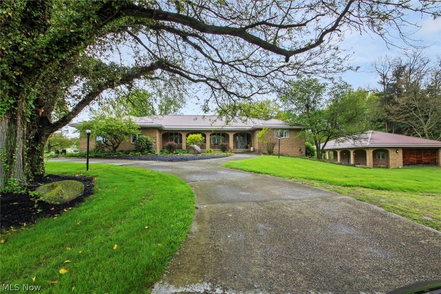 Welcome to this spectacular one-owner custom-built brick estate nestled on 2 private acres giving you plenty of space in Poland. This exceptional home has 5 spacious bedrooms and 5 bathrooms, plus walk out lower level with a full kitchen, bath, laundry and large family room with beautiful stone fireplace.  Lower level is perfect for gatherings, work out area, or even a Mother-In-Law suite.  Both levels of this home have a large, open kitchen and check out the stunning fireplaces, one on each floor! The additional heated 2 car detached garage will delight car enthusiasts and hobbyists alike, offering additional living space in the gorgeous, finished loft complete with kitchenette, laundry, and bath and prepped to add central air...BONUS! Perfect for entertaining, large game room, the space is there! Step outside and discover a property that is just as remarkable as the home. Mature trees surround the grounds offering privacy, and a one-of-a-kind treehouse welcomes folks of all ages to enjoy its space! The 300 square foot 2-story treehouse is equipped with electric, heat, intercom and internet potential. Take advantage of this opportunity to own such a unique property in a highly desirable area. You truly must see this home to appreciate all of its charm, so schedule your private showing today!