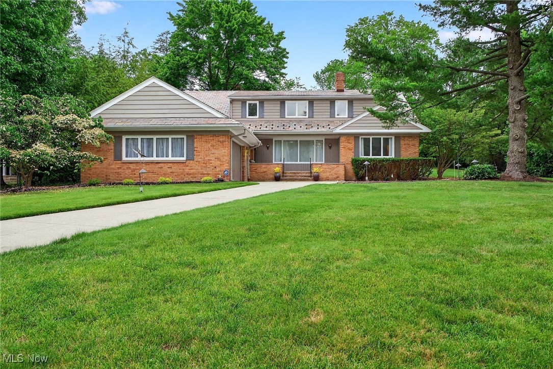Location. Location. Location! Welcome to this stately corner lot home on highly sought-after Shelburne Road in historic Shaker Heights, OH. This 5-bedroom, 5-bath mid-century Cape Cod offers a large circular driveway, spacious two-car attached garage, classic charm, plenty of room for entertaining, and walkable access to John Carroll University and University School Lower Campus (Private K-12 college preparatory school for boys).
The home features a floor-to-ceiling gas fireplace; formal living and dining rooms; a bright kitchen with eating space leading to a large 3-season sunroom off the patio; family rooms on both levels; first floor laundry/utility room; and two master suites--one on each level (ideal for multigenerational living). There is a dedicated space perfect for an office or homeschooling in one first level bedroom. Two full baths on the first level have direct access to the three first floor bedrooms. Ample closets, plus a cedar closet, are throughout.
Upstairs there is a huge full bath for both spacious bedrooms. Hardwood floors are throughout. The huge basement has a 1/2 bath, lots of built-in storage, and a pantry. Outside, the large landscaped yard features mature trees, a large patio, and a built-in grill.