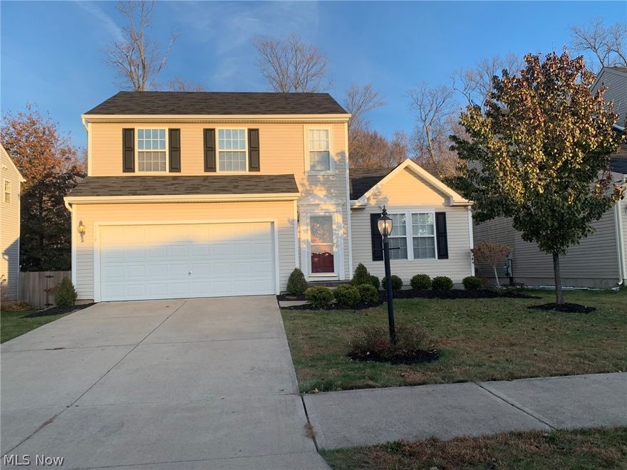 Welcome to this move-in ready, 3 bedroom, 2 and 1/2 bath colonial in the desirable Meadow Lakes subdivision in North Ridgeville. A ceramic tile entryway leads to a spacious, vaulted living room and eat-in kitchen, both featuring laminate wood flooring.  The kitchen boasts fresh paint and black appliances, including a Bosch dishwasher, and a new disposal (2019). The laundry room and half bath, both featuring ceramic tile, finish out the first floor.  Upstairs includes three bedrooms and two full baths. The vaulted master bedroom includes a walk-in closet, and the freshly painted master bath includes a dual vanity and ceramic tile flooring. The second full bath features tile accents above the shower and a ceramic tile floor. The finished basement features plush carpeting and new paint.  A new central A/C unit was installed in 2017.  The outside was recently updated (2018) with all new landscaping and a large 20x20 stamped concrete patio that overlooks the fully fenced-in yard with a wood
