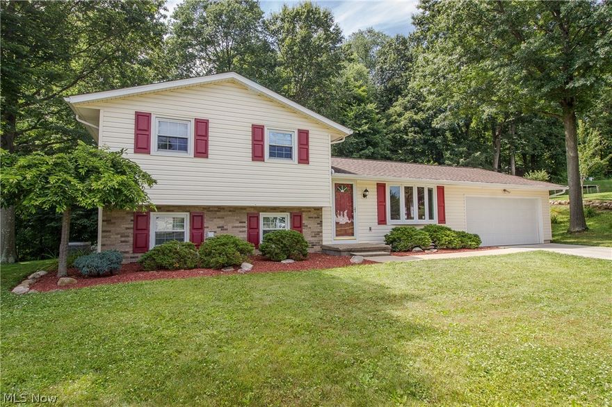 You're going to want to see this home!  Located on a cul-de -sac with a wooded backyard, this home has a very functional floor plan featuring a living room with bow window and chair rail.  The dining area is open to the kitchen with brand new range, refaced cabinets, newer vinyl floor, and door leading to the attached 2 car garage.  A sliding door from the dining room provides access to the tiered deck.  You'll love the lower level family room with wood burning fireplace and another sliding door that leads to the lower level of the deck.  The laundry room offers a convenient half bath too.  Upstairs you'll find all three bedrooms and a full bath with newer vanity, toilet and shower doors.  The yard is just as fantastic with manicured landscaping, fenced area for kids or pets, shed for additional storage plus a private wooded view!  You'll appreciate the recently updated concrete driveway (2006), A/C, siding & windows (2010-2011), water heater (2013/2014) roof (2016) and fresh paint (20