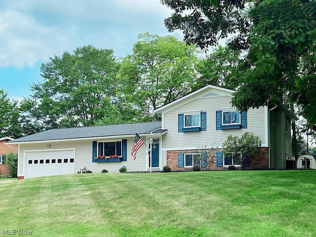 Love, care and good taste are the hallmarks of this immaculate split-level, nestled on an over half-acre lot in one of Fairlawn’s great neighborhoods. Vaulted ceilings in living and dining room. The eat-in kitchen has versatile maple cabinetry, tile backsplash, updated lighting and newer stainless-steel appliances. There is natural light, ample closet space and refinished hardwood floors in all three bedrooms, a lower-level family room with stone wall and built-in fireplace and a walk-out to the outside. Improvements include main bath remodel in 2021, new roof on the house and shed and a new furnace in 2020, kitchen appliances in 2019, quality window blinds in 2018, and more. If you've been looking for a special backyard, you’ll love this one. Off of the back is a 20 ft. long covered patio overlooking a beautiful Uni-lock landscape planter and a huge rear yard where the kids can play or where you can sit and visit for hours with family and friends. The neighborhood has Fort Island/Grif