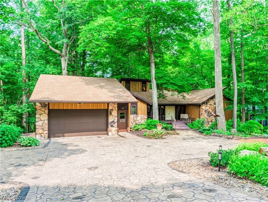 Welcome home to this architecturally innovative 2-story with finished W/O  LL. This home was built by its only owner on a private, heavily wooded lot with a wrap-around deck to take advantage of the beautiful views! It has 4 BDS and 3.5 BA. It incl an updated kit w/Corian counters, solid walnut cabs and woodwork, lg island w/seating for 5. The sunken LR is vaulted and has a stone floor-to-ceiling FP. The 1st floor also has a large DR with broad overhangs
for shade during the p.m. sun. This owner has thought of everything in the construction of this home including a FF laundry rm. Up, the primary BR with a vaulted ceiling boasts a gas FP, a loft with steps to a level that includes bookshelves & add'l solid oak and walnut storage cabinets It also includes a private deck overlooking the secluded, wooded backyard. Off this BR is a nursery currently used as a second W/I closet. A 2nd BR also includes steps to a loft area for bunk beds for the kids! The 3rd BR is currently used as an office