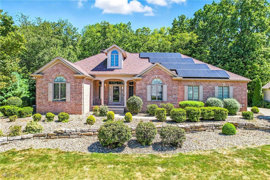 Tranquility awaits at this sprawling expansive ranch, breathtaking private views of ravine run/creek. First floor hosts magnificent great room, vaulted ceilings, cozy fireplace, custom built-ins, & wet bar. Walls of glass frame the serene landscape & open onto an expansive multi-level deck. Your private outdoor oasis complete with hot tub (new cover & circulation pump) new gazebo (2024), & updated deck lighting perfect for enjoying tranquil evenings. Kitchen w/ granite island, ample cabinetry, full suite of appliances that remain for new owner. 1st floor laundry, laundry chute to 2nd lower level laundry. Sun-drenched 4 seasons room offers a flexible space for morning coffee or a quiet reading nook. Retreat to the secluded primary suite, thoughtfully placed in its own private wing w en suite step in shower & tub, large closet. Rounding out the 1st floor are 2nd primary en suite & 3rd bed & bath, a designated office w/ built ins & desk off of the front door. Lower level dramatically expands living space, in-law or guest suite w private access from garage or off 1st floor front door. This exceptional area includes a large family room, fireplace, counter w/ sink, 2 additional flexible rooms ideal for bedrooms or office, & a full bath. Expansive utility rooms & bonus workshop cater to every hobby & storage need w additional storage in walk up attic. Forward-thinking features, including solar panels & an EV charger for sustainable living. Updates: heated garage (2022), landscape lighting (2025), leveled driveway warranted to 2029, a 5-camera security system, generator hookup w/ transfer switch, programmable recirculation pump for instant hot water, radon mitigation system. Roof 2018, Shed 2022, lower level washer/dryer 2019. Expansive home w/ opportunity for 5+ bedrooms. One of a kind ranch awaiting your vision for perfection. Solar panels: 3 inverters w transferrable warranty, OH Edison for net metering & resale electric offer budget friendly electric needs.