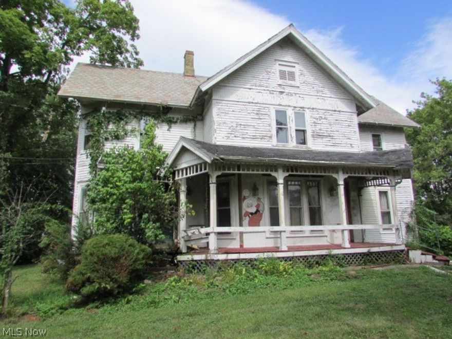 Four bedroom century home with much to offer. This home is waiting for someone to bring it back to it's original luster!  Large living room and dining room.  Dining room is bright and open surrounded by windows. All the natural woodwork still remains!  Four bedrooms with wood floors in second level.  Full bath too!  Private, fenced lot for relaxing.  Centrally located close to schools, shopping and more!  Bring your tool belt and your imagination and make this house a home.  Property sold AS IS.