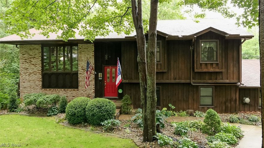 Looking for a beautiful home in a park-like setting? Look no further! This 5 bedroom, 3 bath raised ranch home set on 1.2 mostly wood acres is sure to delight you. This well maintained, custom built home has so many beautiful finishes and touches including slate, hickory and oak flooring throughout. The kitchen has hickory kitchen cabinets, granite countertops, and stainless steel appliances. All three bathrooms have been updated including granite countertops and Travertine tile.
The upper level affords serene views while working in the kitchen, enjoying dinner in the dining room or relaxing in the living room by the one-of-a-kind fireplace. 2 bedrooms and the master bedroom complete the upper floor.
The lower level has a family room with a gas stove that leads to a heated/cooled sunroom with plenty of windows and doors to enjoy the view. The lower level also has two bedrooms, a large laundry room and even has a workshop (with garage door!), and one car attached garage with a potting