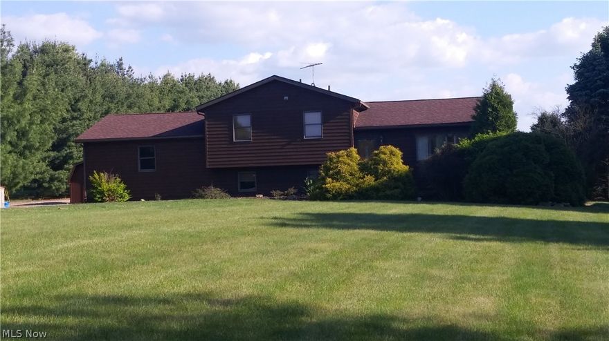 Fantastic Rustic Cedar Split Level Home w/5.28 acres and a 32' x 50' finished pole building w/concrete, electric 220, and large overhead garage door.  Believe me when I say this home is move in ready.  Cozy warm colors and quality throughout.  Completely remodeled floors, Merillot Maple kitchen cabinets, 3 baths, doors, windows, patio, you name it!  Be sure to print the improvement sheet in supplements.  This one owner home built in 1991 has been meticulously maintained by its owner with impeccable taste featuring an open floor plan throughout and warm décor, it presents a cozy lodge feel and flows from room to room while remaining true to its open floor plan.  The eat-in kitchen has all the whistle and bells that quality Merillot Cabinets provide.  It is a dream come true for the cook in your family.  Entertaining and daily comfort is just out the new Anderson sliding door to the stamped concrete patio featuring a built in fire pit and large private acreage in the back.  There is a 32
