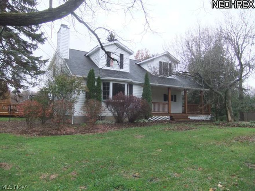 Remodeled kitchen with glazed cabinets, granite counter top, bamboo wood floor in dining room and kitchen, living room with bayed window, stone fireplace, slider to large deck, updated bathroom, finished rec room with nature stone floors, many updates, large outbuilding with electricity - on approximately 2.6 acres.