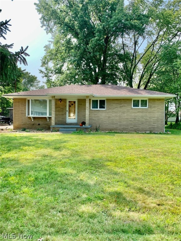 Dont miss this remarkably well maintained all brick ranch in Tallmadge! This home is larger than it looks! Enter through the bright and sunny living room with a large picture window and custom rustic fireplace surround. From there you will find a very large eat in kitchen with an updated retro feel offering stainless appliances, plenty of counter and cabinet space, a double door pantry and room for a large table. Down the hall are 3 nicely sized bedrooms and a full bath with linen cabinet and plenty of counter space to get ready. Gorgeous hardwoods throughout the first floor! Head down the stairs flanked by a custom wall treatment and vintage industrial lighting to a fantastic family room, with a built in bar area and sweet retro cow fridge that stays with the home! This place has room for hosting all the parties!!! If you were planning for a cozy night in, dont miss the theater room, with platform seating for you and your friends! Around the corner you'll find a great additional