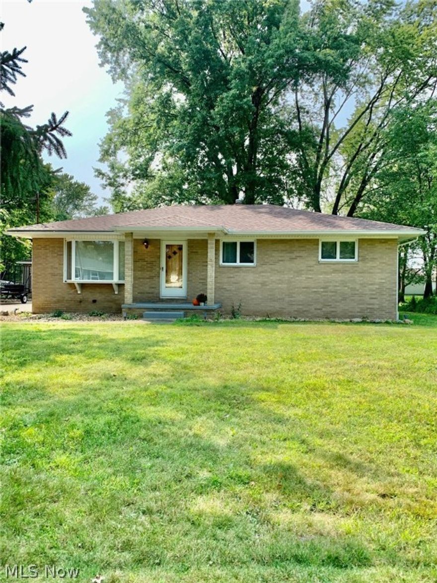 Dont miss this remarkably well maintained all brick ranch in Tallmadge! This home is larger than it looks!  Enter through the bright and sunny living room with a large picture window and custom rustic fireplace surround. From there you will find a very large eat in kitchen with an updated retro feel offering stainless appliances, plenty of counter and cabinet space, a double door pantry and room for a large table.  Down the hall are 3 nicely sized bedrooms and a full bath with linen cabinet and plenty of counter space to get ready.  Gorgeous hardwoods throughout the first floor! Head down the stairs flanked by a custom wall treatment and vintage industrial lighting to a fantastic family room, with a built in bar area and sweet retro cow fridge that stays with the home!  This place has room for hosting all the parties!!!  If you were planning for a cozy night in, dont miss the theater room, with platform seating for you and your friends! Around the corner you'll find a great additional