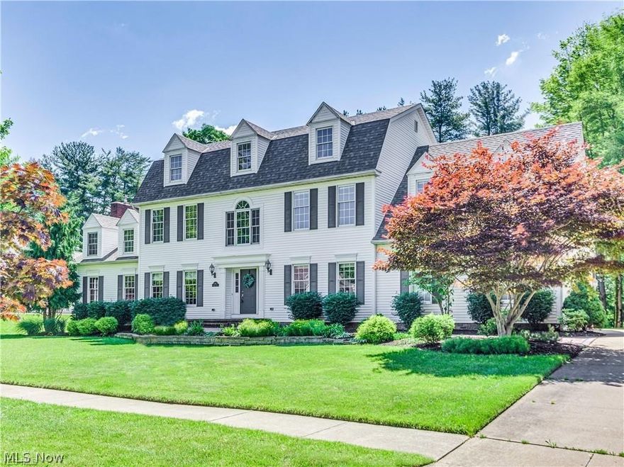 Welcome home to this stunning Hudson colonial in desirable Oak Point Commons. Enter through the impressive two story foyer flanked by a sunny dining room and office or formal family room. Through the hall you will find a a light filled open floorpan with sight lines from room to room offering the perfect layout for modern living. The chef’s kitchen boasts eat-in center-island, cherry cabinetry, granite counter tops, and high end stainless appliances, including wine cooler plus an area for casual dining. The great room offers a stately floor to ceiling wood burning fireplace, soaring ceilings and clearstory windows. Beyond the great room you will enjoy views into the serene morning room with walls of windows offering view of the private wooded back yard and sprawling stamped concrete patio. The first floor is finished off with a spacious mudroom/laundry and half bath. Upstairs you will find all 4 large bedrooms.  The owner’s suite has cathedral ceilings and a spa like en suite with rece