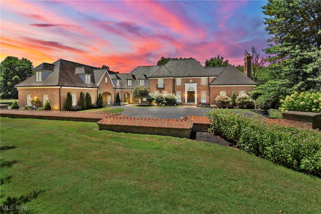 This extraordinary estate in Novelty, designed by renowned architect Tony Paskevich, offers more than 11,000 square feet of living space with 5 bedrooms, 7 full baths, and 3 half baths between the main home and pool house. A rare blend of scale, craftsmanship, and amenities, the property showcases brick and stone hardscaping, stacked stone walls, fountains, and multiple patios- one of which is covered and designed for entertaining, with five sets of French doors opening directly into it from the main house. A resort-style pool area features a Vegas-inspired infinity edge and Roman-style hot tub, while the separate pool house functions as a full guest home with kitchen, bunk area, full bath, washer/dryer, and private entry. The main house includes a dramatic foyer with a sweeping staircase and a Murano glass chandelier imported from Italy- a stunning focal point that sets the tone for the refined design throughout. The great room features soaring ceilings, a full wet bar with seating, and rich wood-paneled walls that add warmth and grandeur. A spectacular modern living room showcases a marble fireplace and expansive windows that flood the space with natural light. The kitchen looks straight out of a design magazine, with two oversized center islands, sleek cabinetry, top-tier appliances, and a cozy hearth room overlooking the scenic backyard. Additional highlights include a sophisticated home office and four fireplaces. The home offers five well-appointed bedrooms, each with its own en-suite bath, including a spacious bonus or in-law suite. The primary suite is thoughtfully designed with two full bathrooms, generous closet space, and complete privacy. The lower level includes a large family room, exercise area, and golf simulator. Ideally located just a short drive to Chagrin Falls, Hunting Valley, and top-rated private schools including Gilmour Academy, University School, and Hawken. A rare opportunity to own a one-of-a-kind estate in an exceptional setting.
