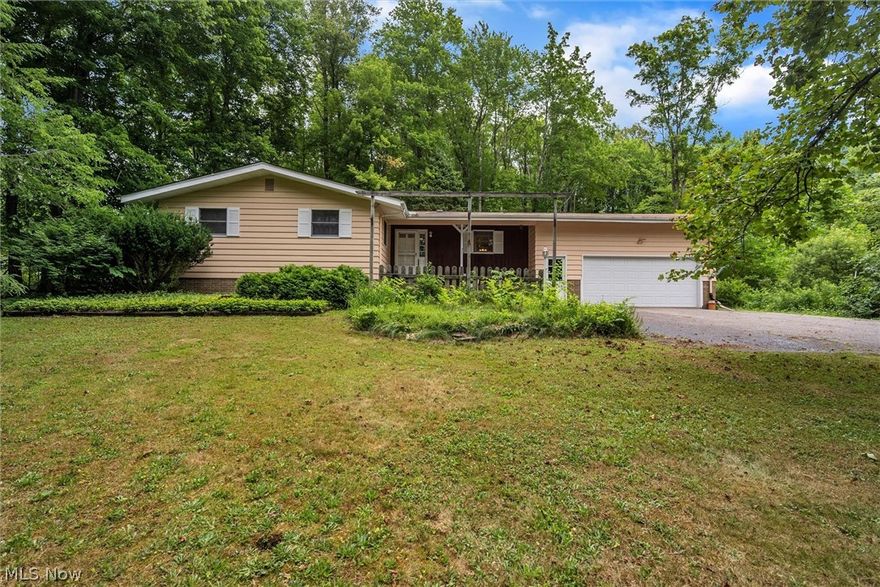 This charming ranch welcomes you with a front patio that is the perfect place to enjoy your morning cup of coffee. Through the front door you will find the kitchen with plenty of cabinet space, a pantry and a window overlooking the front yard. Continue to the dining room and living room with a large picture window that gives plenty of natural light and a fireplace to keep you warm all winter long with beautiful wooden built-ins on both sides. The master suite features spacious closets and ensuite bathroom with a tile surround shower. Two more bedrooms and a full bath round out the first floor. Hardwood floors under the carpet in the bedrooms. The basement has so many possibilities with a large recreation room, a workshop area with tons of storage space and a laundry room. Spacious attached two car garage. This beautiful 1 acre lot has lush mature trees that you won't want to miss!