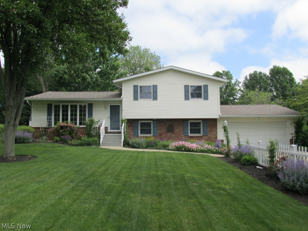 Pride of Ownership and Quality Care updates set this home apart * Custom Legacy kitchen cabinetry are plentiful, granite countertops, built-in glass hutch and pantry added, stainless steel appliances complete with beautiful easy-care engineered Bruce hardwood flooring which extends through the foyer * Six panel doors, full-wall brick gas fireplace, modern décor, 7 x 8 mud room handy to attached garage just names a few amenities * Dining room leads to retractable SunSetter awning on 12 x 24 composite deck for relaxation and entertainment * Stunning ceramic-tiled bathrooms are spacious * Professionally landscaped to enjoy blooming perennials all seasons on a level lot 100 x 200 * Extra-wide concrete drive with extra parking * Great storage areas * Fenced garden area * Basement area 21 x 25 with R-30 insulation ready to finish for your preferences * All ready, willing and preapproved buyers will appreciate all the attention to detail this very lovely home offers!