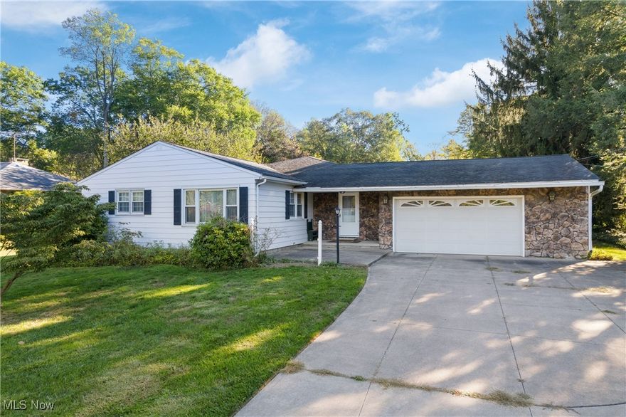 Welcome to this inviting 3-bedroom, 2-bath ranch nestled in the desirable Clearview Acres allotment. Offering the perfect balance of a rural setting with the convenience of public sewer, this home sits on just over an acre, providing plenty of space for outdoor living and recreation. Step inside to find an expansive family room addition featuring vaulted, wood-clad ceilings and large windows that bring in natural light—ideal for gatherings or simply relaxing. The open flow continues with an eat-in kitchen, spacious dining area, and cozy living room. Hardwood flooring, built-in features, and natural woodwork add timeless character throughout. Outdoors, enjoy an expansive back patio that overlooks a private, tree-lined yard—perfect for entertaining, summer barbecues, or unwinding with nature as your backdrop. For active living, a full basketball court provides year-round fun right in your backyard. Additional highlights include a partially finished basement with two bonus rooms and a full bath, an attached 2-car garage, and the furnace is approx. 3 years old. Situated in Wadsworth Township with easy access to town, this property offers the best of both worlds—quiet country-style living within minutes of schools, shopping, and major routes.