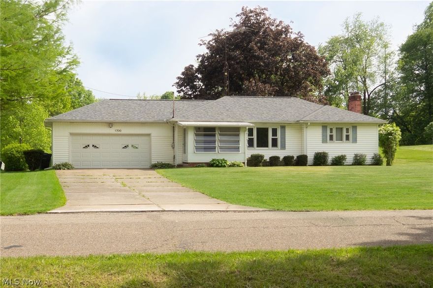 This cute & clean, one-owner ranch features 3 bedrooms, 1 full bathroom, 1,124 sq ft of living space and 2-car attached garage, all on one spacious lot in the City of Green. As you enter through the enclosed front porch with louvered windows, you will be greeted by the summer breeze. Proceeding through the front door of the home, the living room provides a nice buffer between the kitchen and bedrooms. In the kitchen, you'll find abundant natural wood cabinets and space for a dining table. On the other side of the living room, 3 bedrooms and a bathroom invite you to rest and relax. A full basement provides room for storage and laundry, plus a high efficiency furnace. You'll be ready to host your summer barbeques in the verdant backyard. New roof installed in 2021. Put your finishing touches on this one!
