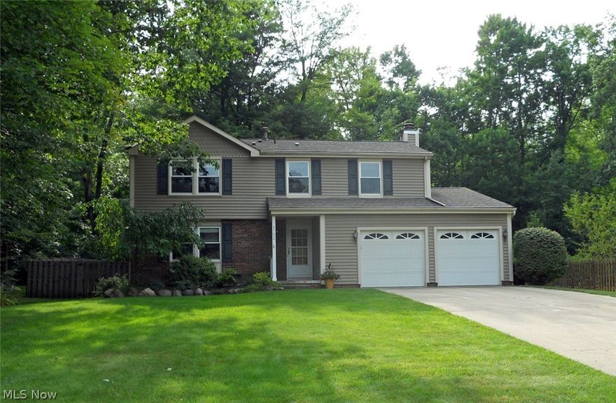 This gorgeous Macedonia, Ohio center hall colonial home is conveniently situated half between Akron and Cleveland with easy freeway access. Shopping, theaters, casinos and restaurants are just minutes away. This quality built home is situated on park like ½ acre and has been lovingly maintained and updated by the owners. This home features 4 bedrms and 2.5 bathrms. The fully applianced, spacious eat-in kitchen features a breakfast bar, granite counter tops, Kraftmade maple inset cabinets, under cabinet lighting, ceramic flooring and lots of storage space. There is a Butler pantry with a wine refrigerator. There is a formal Dining room. The expanded family room has a wood burning fireplace, and recessed lighting. From the family room there is a slider that leads to a 4 season sunroom/greenhouse heated with a natural gas fired replica of a wood burning stove. From the sun room you have access to the deck and rear patio located the park-like fenced in back yard. There is also a formal liv