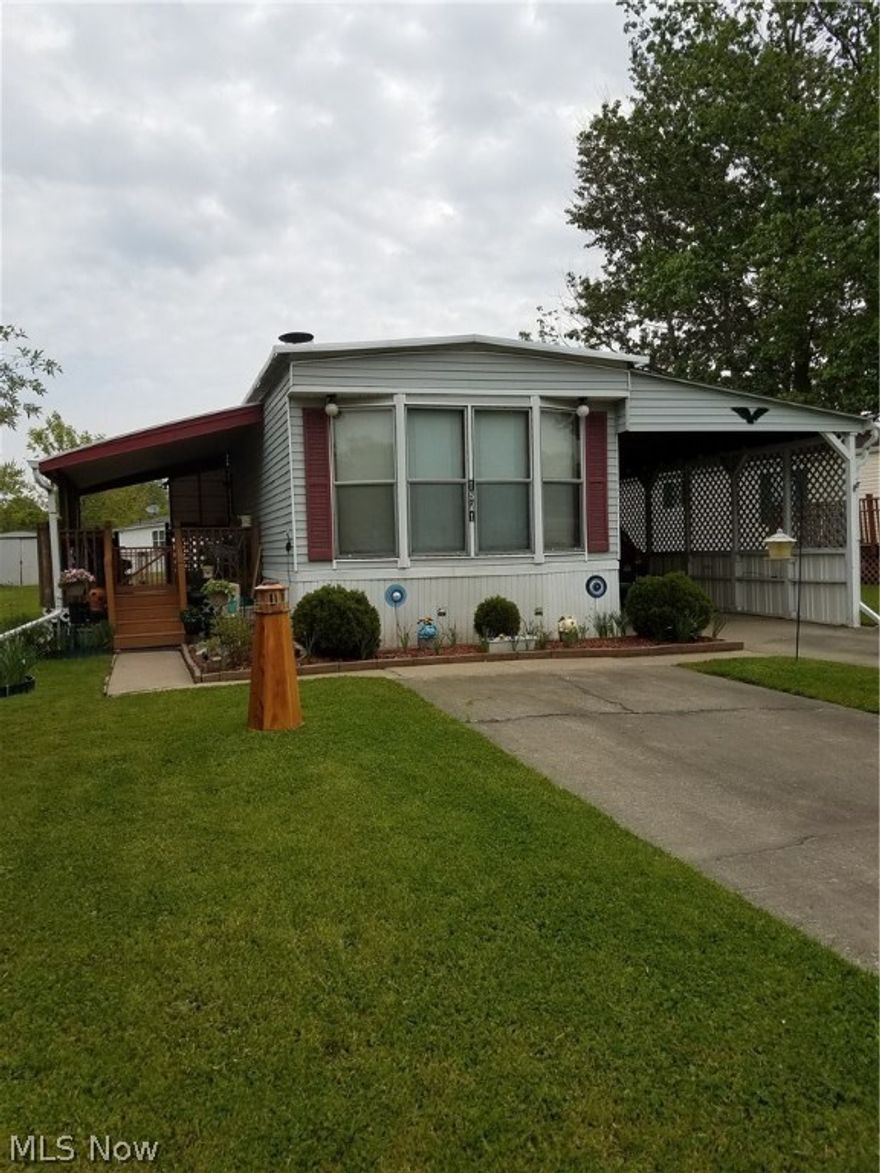 Come home to Camelot village. This well maintained  2 bedroom, 1 bath mobile home is cozy and inviting. Nice kitchen with breakfast bar and plenty of counter and storage  space. Enjoy the fireplace and bank of bay windows in family room. Beautifully cared for lawn with a nice storage shed, covered porch with ample seating perfect for those summer evenings. A partially enclosed carport and storage shed.
Excluded from sale- peonies and lighthouse in yard.