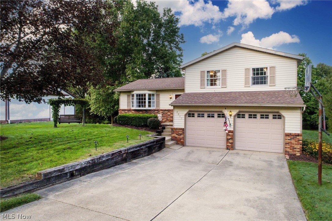 Welcome to this beautifully maintained, clean and bright 3BD/2BA split-level situated just a stone’s throw from KSU stadium and campus, NeoMed, and Kent's vibrant downtown restaurants and shopping. The open floor plan features an inviting living room with bay windows and gas fireplace that includes a wood mantle with ceramic tile inlay and hearth, and it flows into the roomy eat-in kitchen with plentiful cabinets and newer black stainless appliances (2020). Adjacent to the dining area, the sliding patio door leads to the large deck that is perfect for entertaining and overlooks the flat and private .5-acre backyard nestled among the trees. Upstairs, are 3 nicely sized bedrooms – the largest with direct access to the shared full bath. Downstairs, enjoy the welcoming and cozy family room that grants easy entry from the 2-car garage and includes 2 roomy closets and a conveniently located second full bathroom. The clean and dry basement/utility offers a pleasing laundry area (washer/dryer