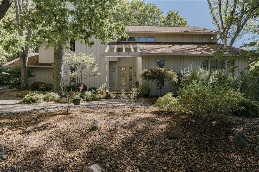 A striking Colonial Contemporary in Pepper Pike, this custom-built home is privately set on a professionally landscaped lot in the sought-after Orange School District. Blending timeless architecture with modern upgrades, it offers the perfect balance of elegance, comfort, and functionality. A dramatic two-story foyer opens to the family room with soaring ceilings, a fireplace with the home’s original stone surround, custom built-ins, and walls of windows leading to a refreshed deck. The chef’s kitchen boasts a granite center island, double ovens, and abundant cabinetry, with a sunlit dining nook that flows into the screened-in porch overlooking the lush backyard. A den with built-ins provides a cozy retreat, while a formal dining room with gleaming hardwood floors elevates gatherings and celebrations. A versatile first-floor bedroom adds convenience and flexibility to the floor plan. Upstairs, the spacious primary suite features a walk-in closet, custom built-ins, a charming window seat with storage, and a newly updated bath. Three additional bedrooms and a full bath complete the second floor. The finished lower level expands your living options with a recreation room and generous storage. Every detail has been refreshed: brand-new roof (2024), fresh interior paint, updated flooring, all-new light fixtures, and exterior landscape lighting. Additional highlights include a heated three-car garage with Nature Stone flooring and a first-floor mudroom/laundry. This home is more than a residence—it’s a private retreat designed for refined everyday living and effortless entertaining.